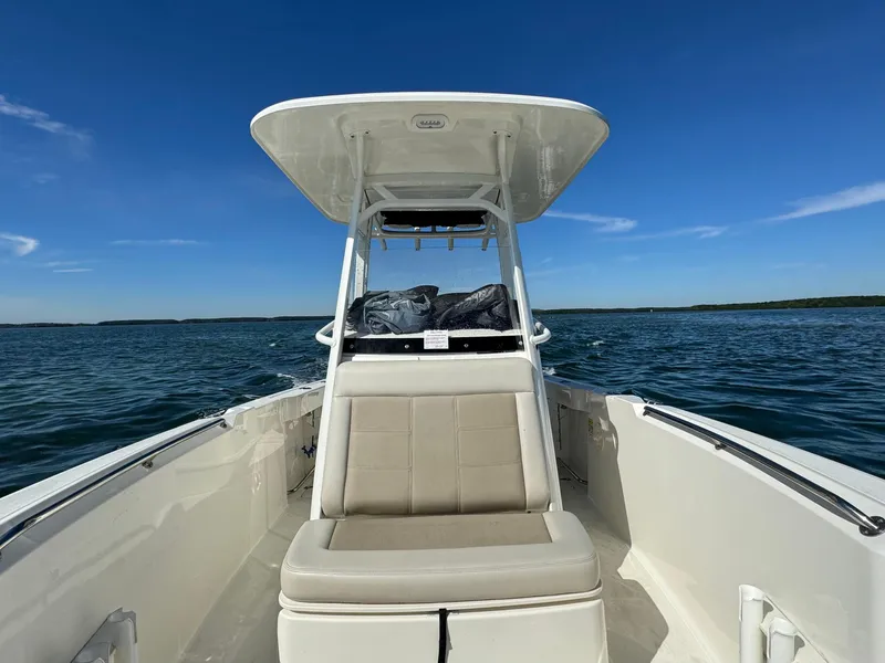 Slide: The Image of 2022 Boston Whaler 230 Outrage boat on open water under clear blue sky. - 29