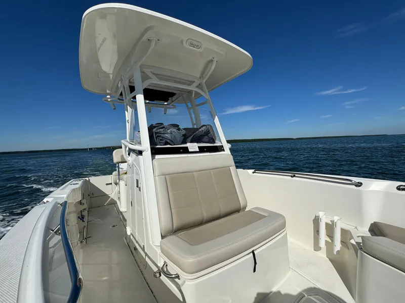Slide: The Image of 2022 Boston Whaler 230 Outrage boat on open water under clear blue sky. - 31