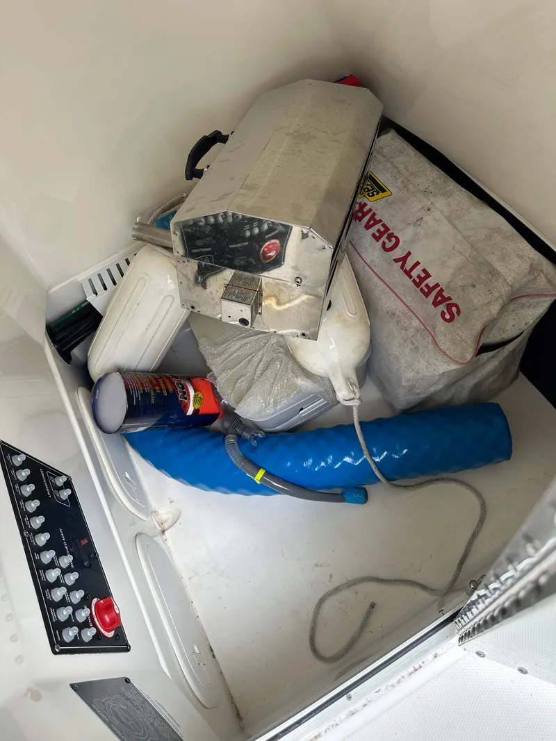 Slide: The Image of Storage compartment of a 2022 Boston Whaler 230 Outrage with safety gear and equipment. - 34