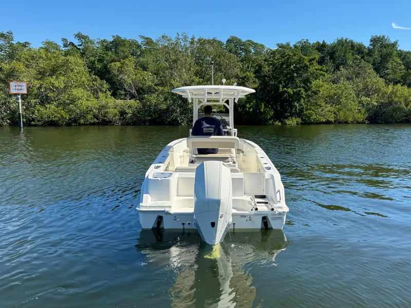 Slide: The Image of 2022 Boston Whaler 230 Outrage boat cruising on a calm river. - 5