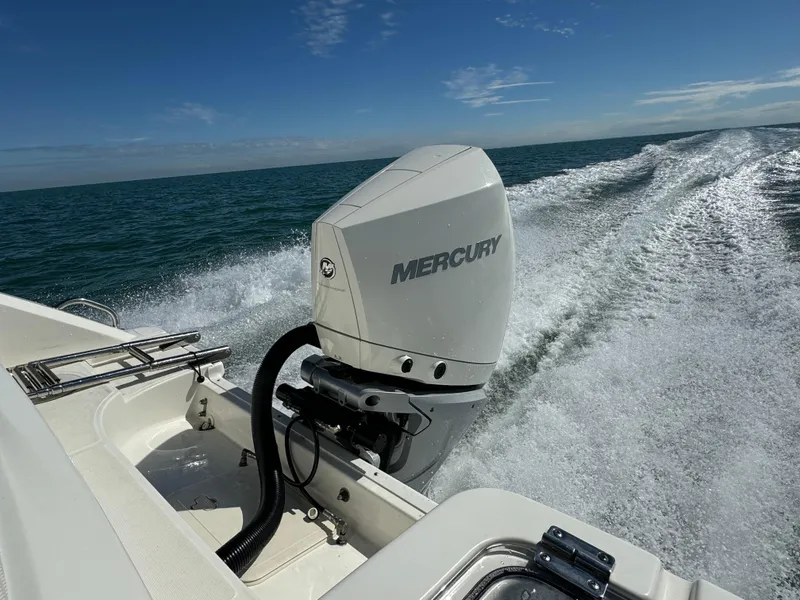 Slide: The Image of Boston Whaler 230 Outrage 2022 with Mercury outboard motor cruising on open water. - 7