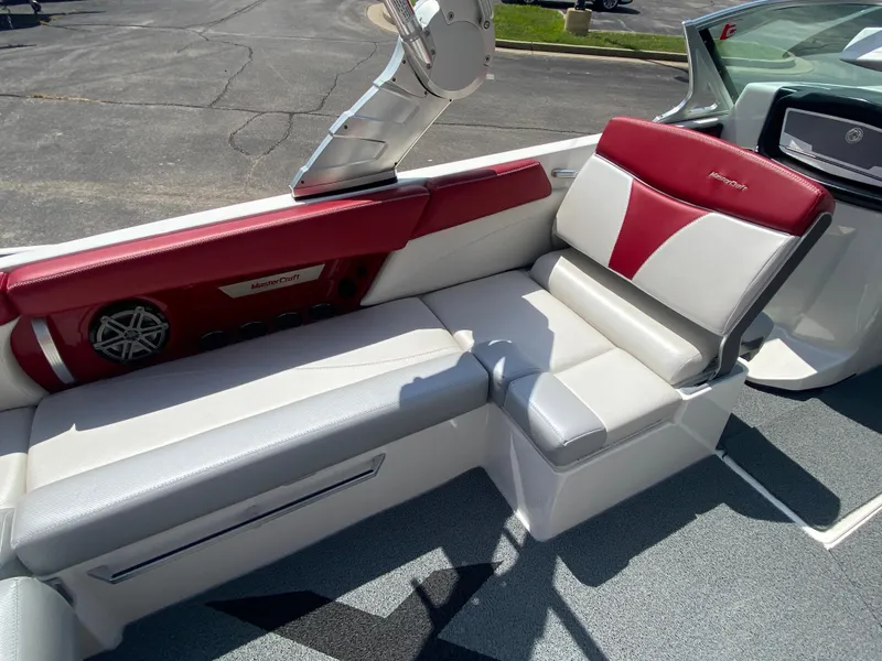 Slide: The Image of 2017 MasterCraft X26 boat interior with red and white seating, featuring a built-in speaker. - 13