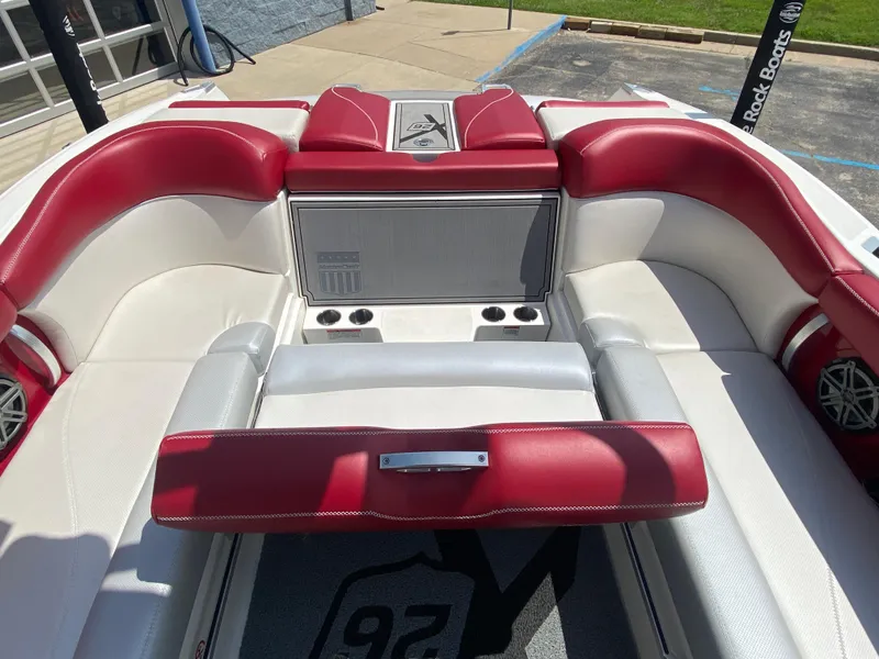 Slide: The Image of 2017 MasterCraft X26 boat interior with red and white seating, cup holders, and premium upholstery. - 14