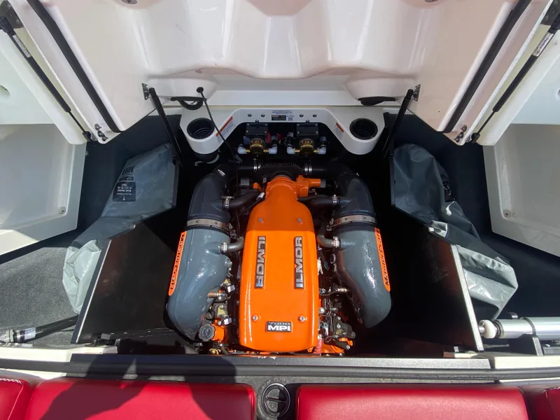 Slide: The Image of 2017 MasterCraft X26 engine compartment with Ilmor engine, featuring orange and gray components. - 15