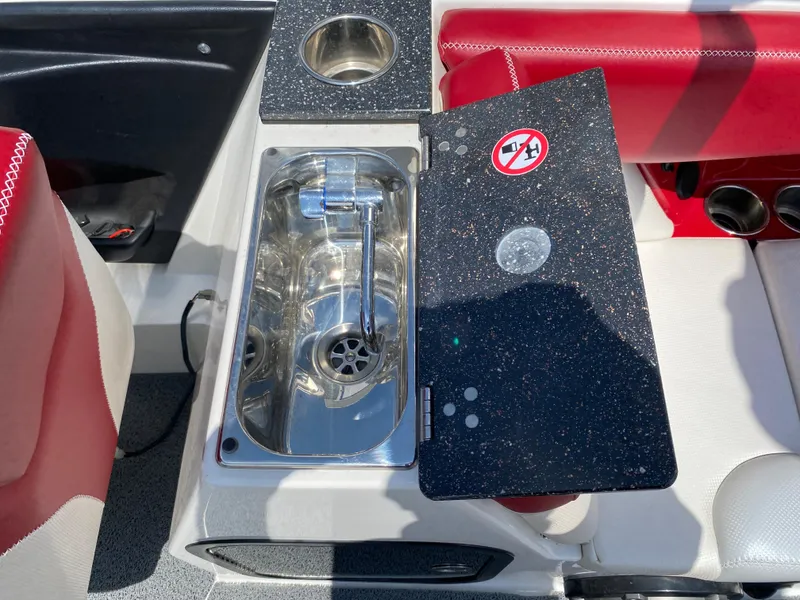 Slide: The Image of 2017 MasterCraft X26 boat sink and cup holder with red and white seating. - 17