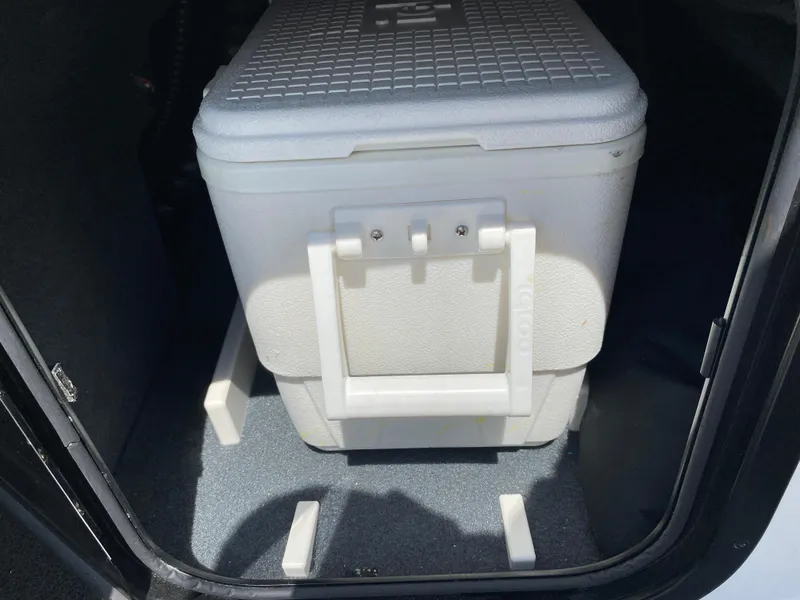Slide: The Image of White cooler inside a 2017 MasterCraft X26 boat storage compartment. - 18