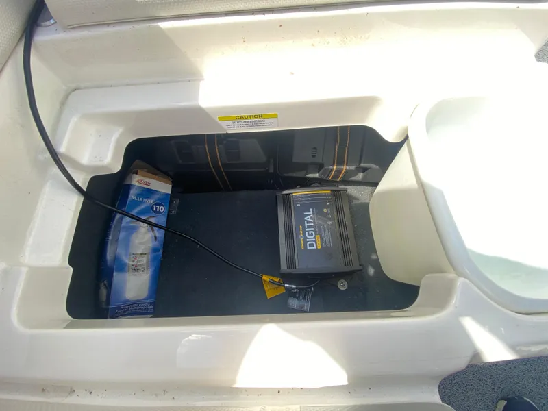 Slide: The Image of Storage compartment in a 2017 MasterCraft X26 boat with digital equipment. - 20