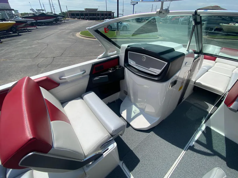 Slide: The Image of 2017 MasterCraft X26 boat interior with red and white seating, modern dashboard, and open cockpit. - 22