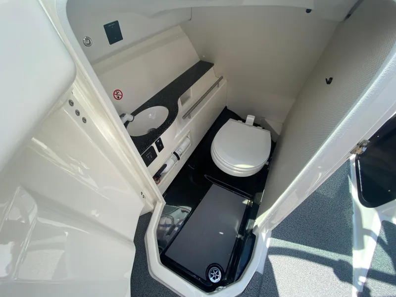 Slide: The Image of 2017 MasterCraft X26 boat interior bathroom with sink and toilet. - 25