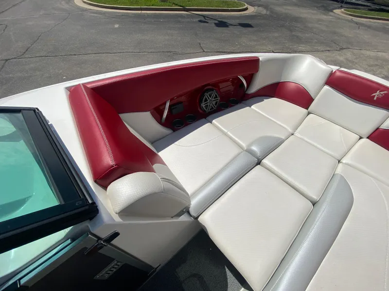 Slide: The Image of 2017 MasterCraft X26 boat interior with red and white seating. - 27
