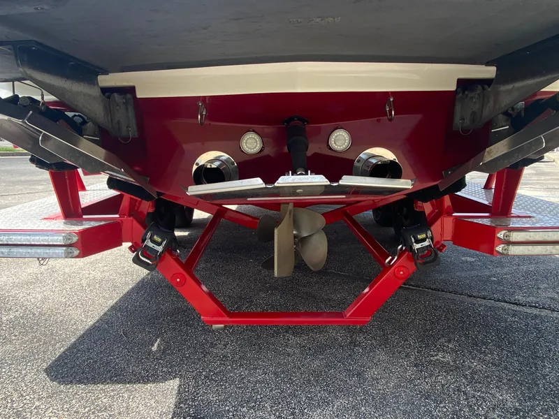 Slide: The Image of Rear view of a 2017 MasterCraft X26 boat showing propeller and trim tabs. - 36