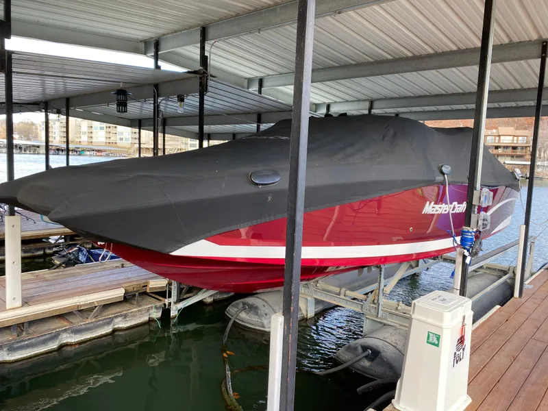 Slide: The Image of 2017 MasterCraft X26 boat covered and docked in a marina. - 38