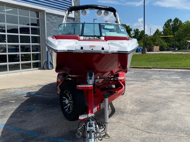 Slide: The Image of 2017 MasterCraft X26 boat on trailer, parked outdoors near a garage. - 4