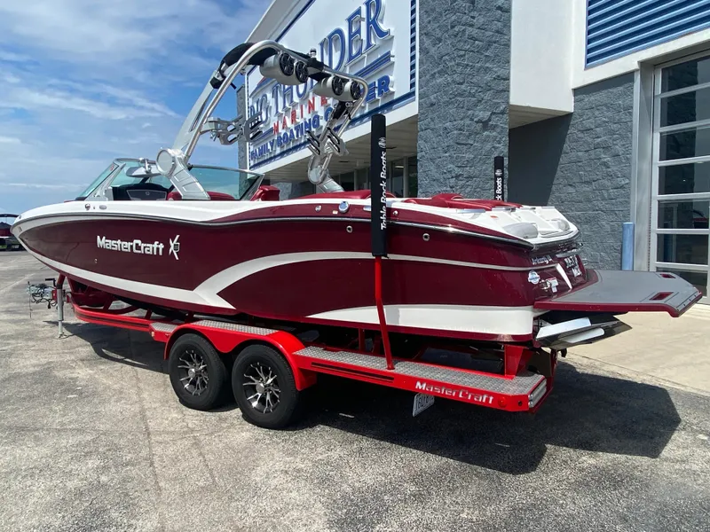 Slide: The Image of 2017 MasterCraft X26 boat on a red trailer outside a dealership. - 6