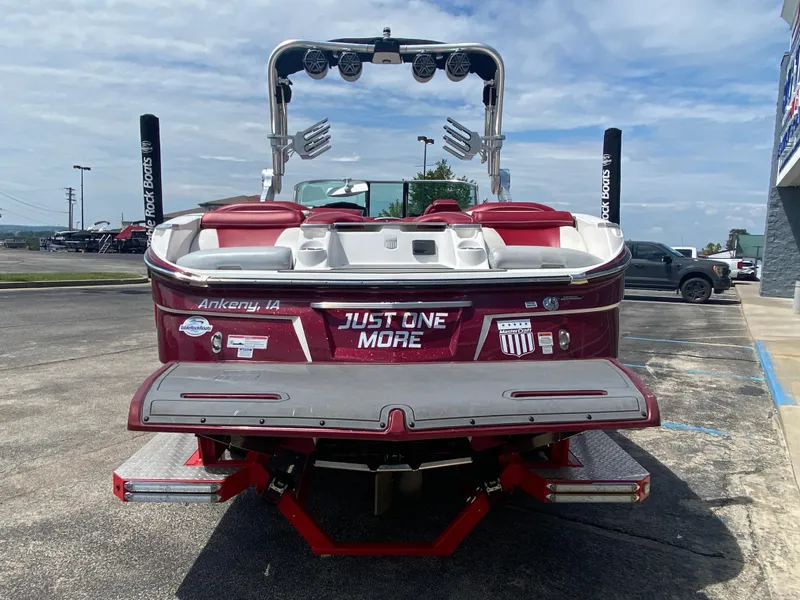Slide: The Image of 2017 MasterCraft X26 boat, red and white, rear view with "Just One More" text. - 7
