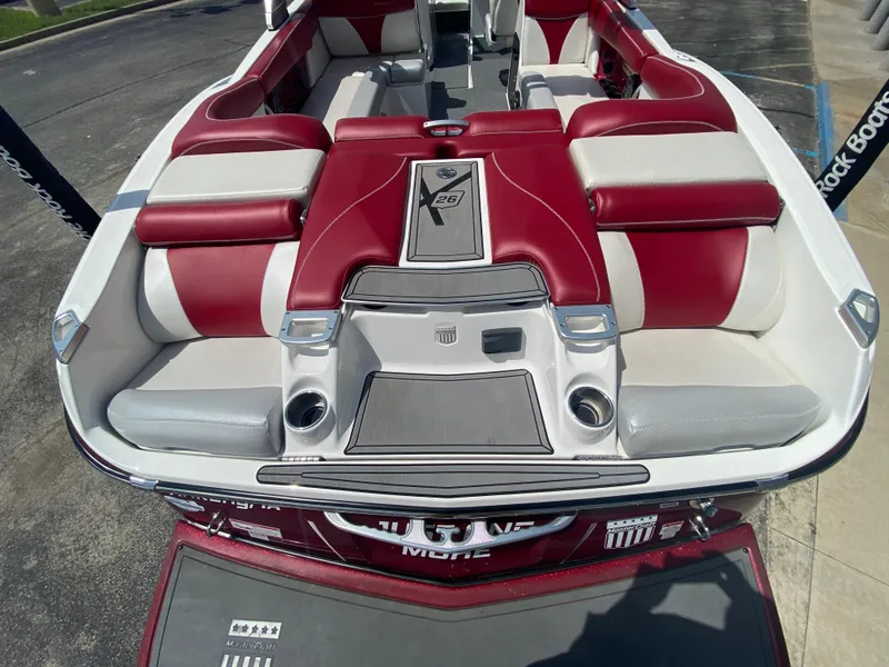Slide: The Image of 2017 MasterCraft X26 boat interior with red and white seating, showcasing luxury and comfort. - 8