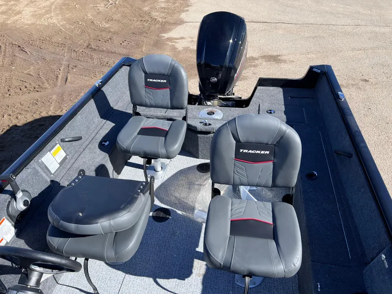 Slide: The Image of 2024 Tracker Pro Guide V-16 SC fishing boat interior with seating and motor. - 10