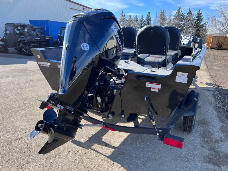 Slide: The Image of 2024 Tracker Pro Guide V-16 SC boat with outboard motor, rear view. - 2