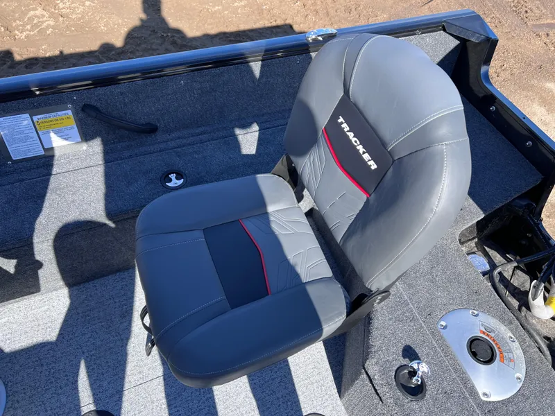 Slide: The Image of 2024 Tracker Pro Guide V-16 SC boat seat with gray upholstery and red accents. - 4