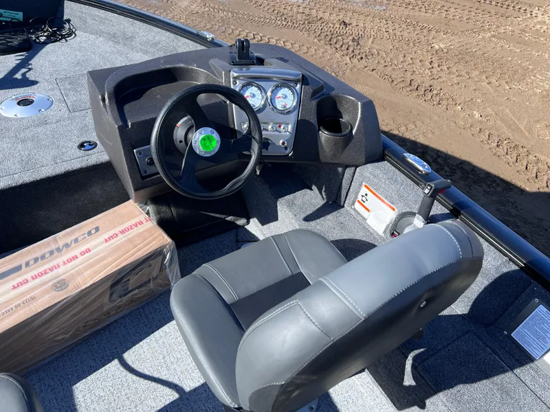 Slide: The Image of 2024 Tracker Pro Guide V-16 SC boat cockpit with steering wheel and gauges. - 6