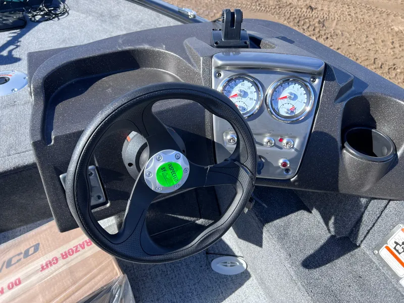 Slide: The Image of 2024 Tracker Pro Guide V-16 SC boat dashboard with steering wheel and gauges. - 8