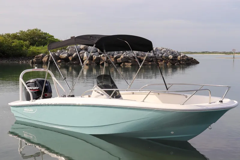 Slide: The Image of 2024 Boston Whaler 160 Super Sport boat on calm water with canopy. - 10