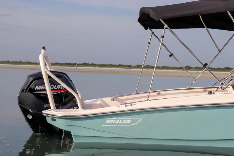 Slide: The Image of 2024 Boston Whaler 160 Super Sport boat with Mercury engine on calm water. - 11