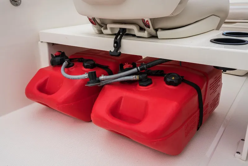 Slide: The Image of Red fuel tanks under seat in 2024 Boston Whaler 160 Super Sport boat. - 24