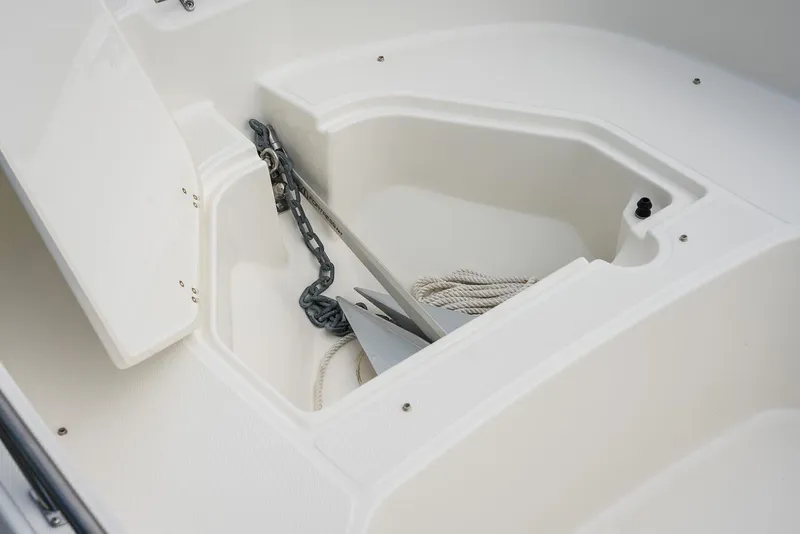Slide: The Image of 2024 Boston Whaler 160 Super Sport anchor storage compartment with chain and rope. - 27