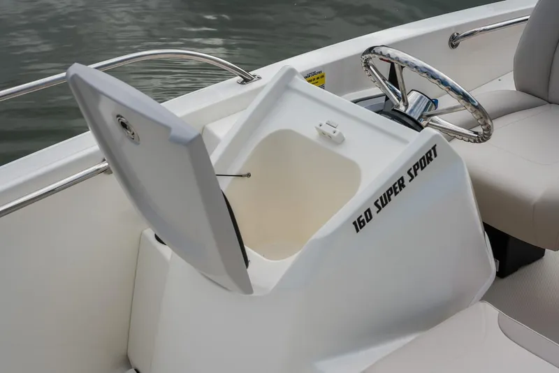 Slide: The Image of 2024 Boston Whaler 160 Super Sport boat interior with open storage compartment. - 28