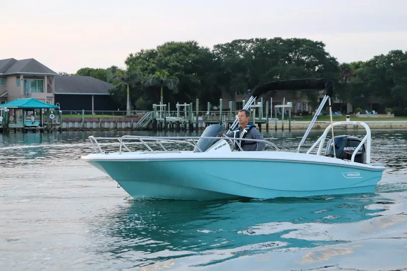 Slide: The Image of 2024 Boston Whaler 160 Super Sport boat cruising on calm water. - 3