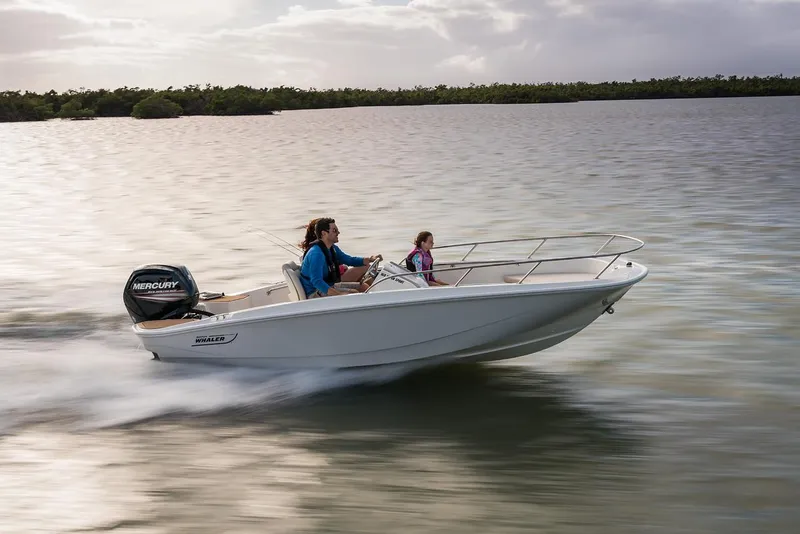 Slide: The Image of 2024 Boston Whaler 160 Super Sport cruising on a calm lake at sunset. - 30