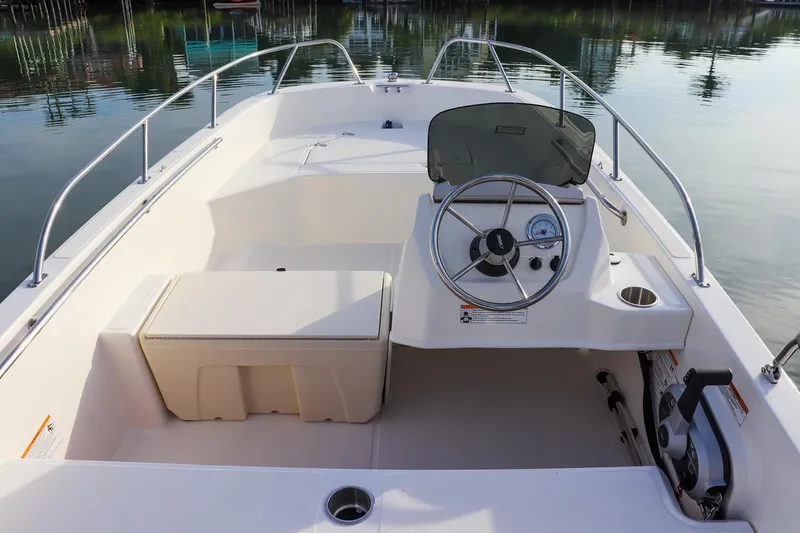 Slide: The Image of 2024 Boston Whaler 160 Super Sport boat interior with steering console and seating. - 33