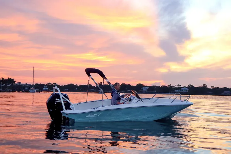Slide: The Image of 2024 Boston Whaler 160 Super Sport on serene water at sunset. - 34