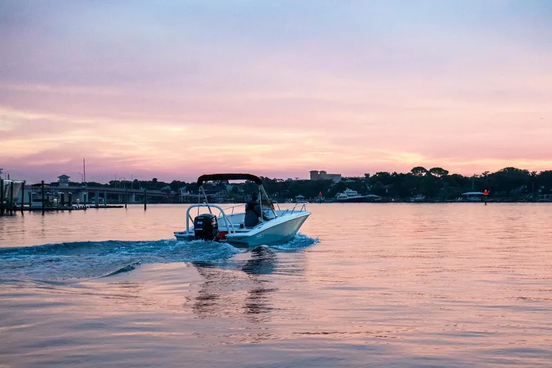 Slide: The Image of 2024 Boston Whaler 160 Super Sport cruising at sunset on calm waters. - 35