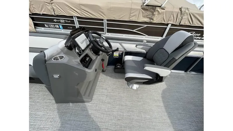 Slide: The Image of 2024 Avalon 2385 V 85 CR boat helm with steering wheel and captain's chair. - 8