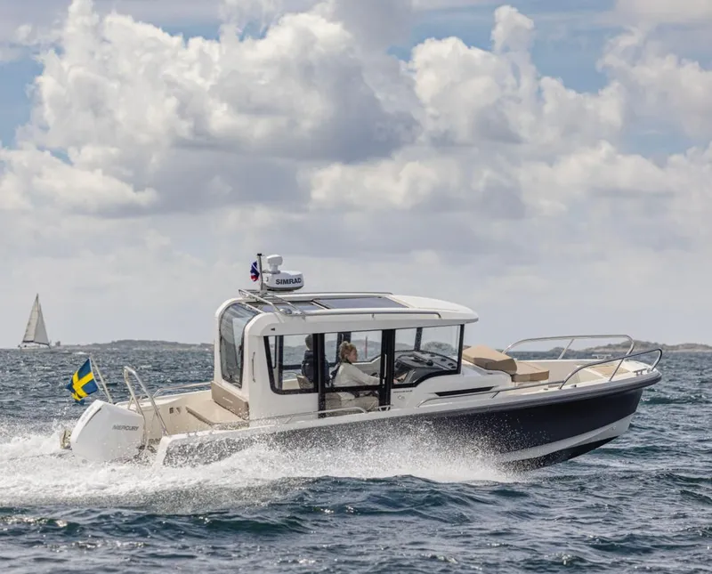 Slide: The Image of 2024 Nimbus C8 boat cruising on open water under a cloudy sky. - 18