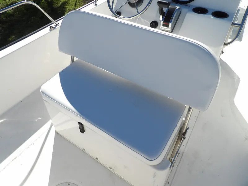 Slide: The Image of 2008 Boston Whaler 190 Nantucket boat interior with white cushioned seating. - 11