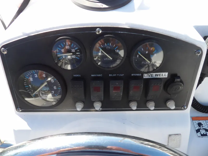 Slide: The Image of Dashboard of a 2008 Boston Whaler 190 Nantucket boat with gauges and switches. - 15