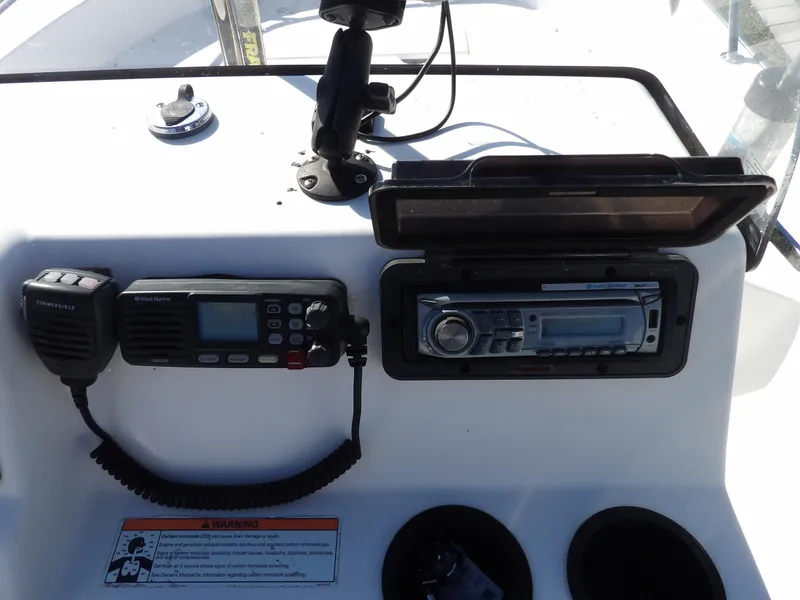 Slide: The Image of 2008 Boston Whaler 190 Nantucket boat console with radio and navigation equipment. - 16