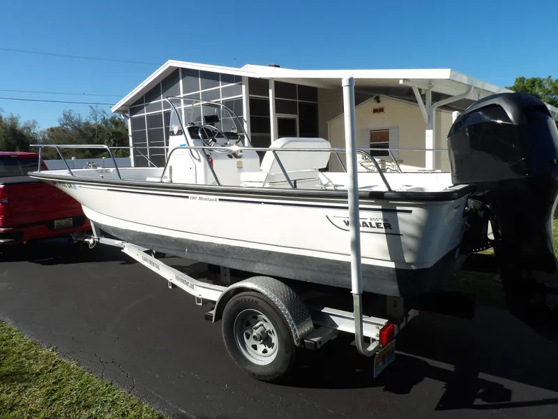 Slide: The Image of 2008 Boston Whaler 190 Nantucket boat on trailer in driveway. - 2