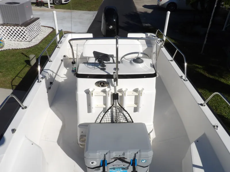 Slide: The Image of 2008 Boston Whaler 190 Nantucket boat interior with steering console and fishing gear. - 3