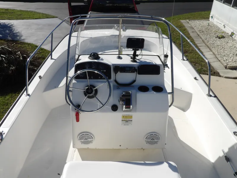 Slide: The Image of 2008 Boston Whaler 190 Nantucket boat interior with steering console and navigation equipment. - 4