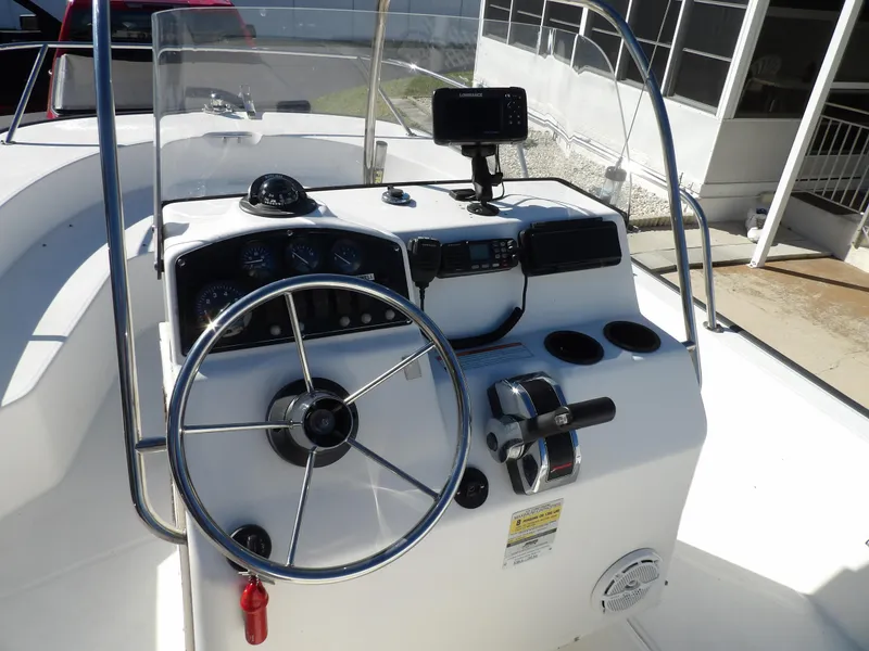 Slide: The Image of 2008 Boston Whaler 190 Nantucket boat console with steering wheel and navigation equipment. - 7