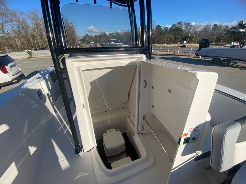 Slide: The Image of 2024 Robalo R200 Center Console boat with open storage compartment. - 15