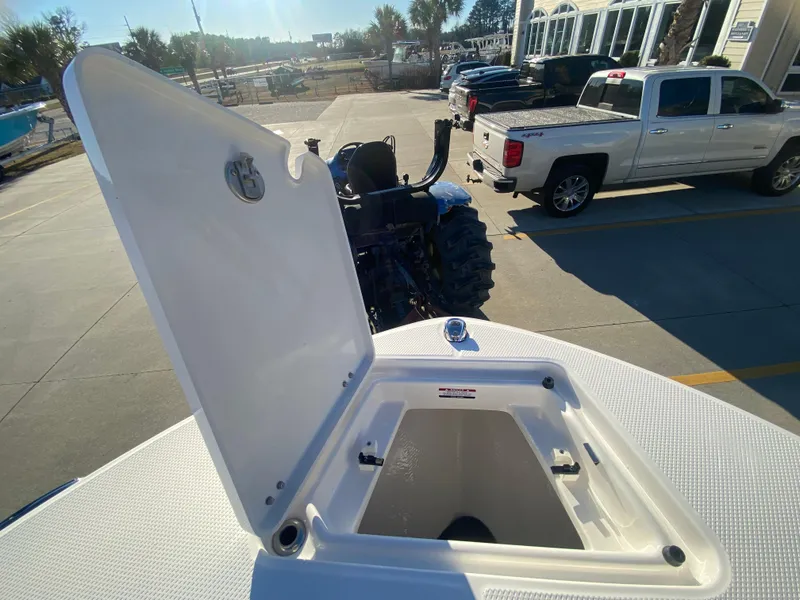 Slide: The Image of 2024 Robalo R200 Center Console storage compartment open. - 18