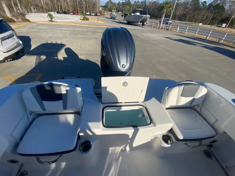 Slide: The Image of 2024 Robalo R200 Center Console boat interior with seating and outboard motor. - 8