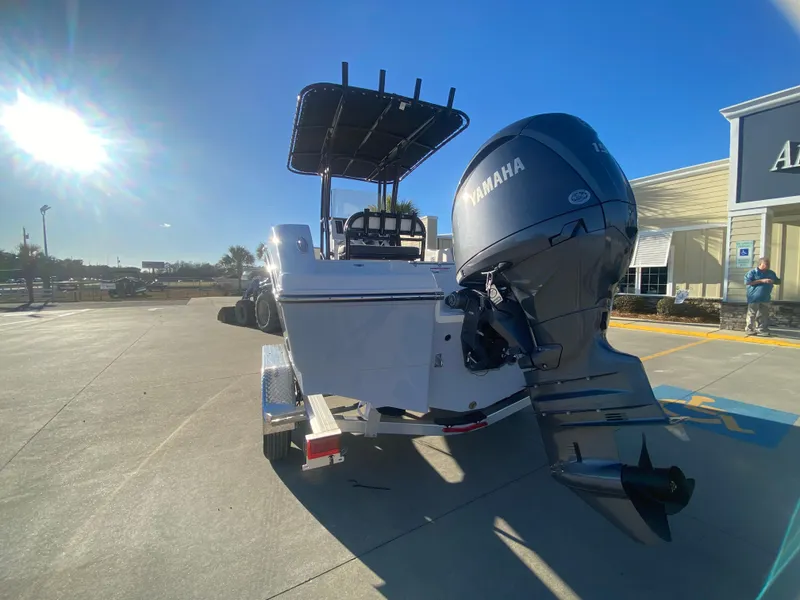Slide: The Image of 2024 Robalo R200 Center Console boat with Yamaha engine in parking lot. - 5