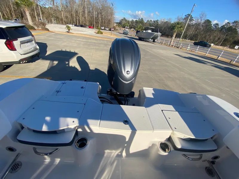 Slide: The Image of 2024 Robalo R200 Center Console boat with outboard motor in parking lot. - 6