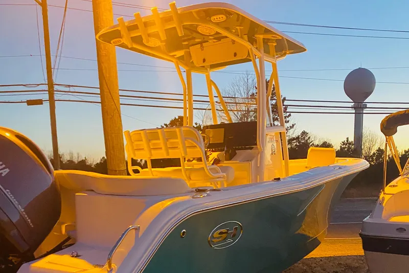 Slide: The Image of Sea Hunt Ultra 229 boat, 2021 model, parked at sunset. - 3
